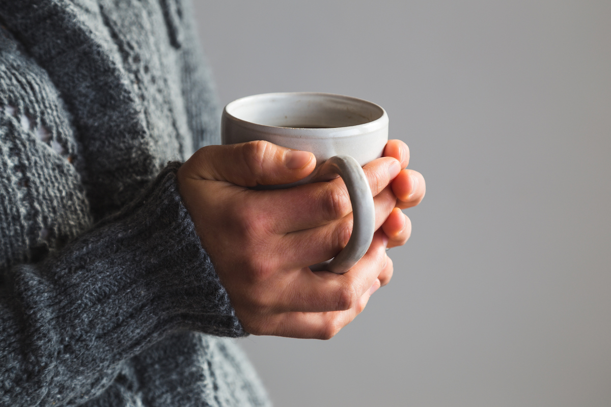 Woman holding hot drink in winter